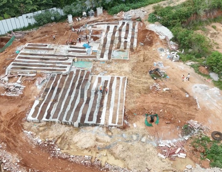 Drone view of a compact build site with grade slab and stored wall panels